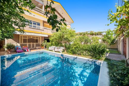 a swimming pool in front of a building at Vila Rroshaj in Tirana