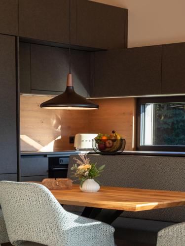a kitchen with a table with a vase of flowers on it at Lodge am Wasser in Yspertal