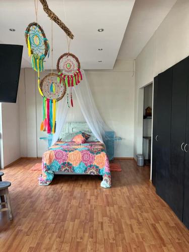 a bedroom with a bed and hanging decorations at Sea sight appartment in Historic Downtown in Campeche