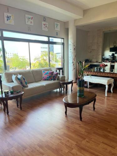 a living room with a couch and coffee tables at Sea sight appartment in Historic Downtown in Campeche