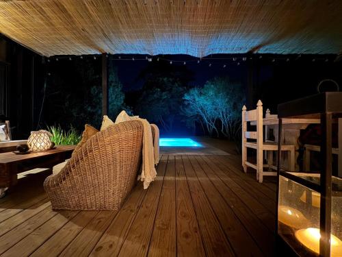 a room with a couch on a wooden deck at night at Casa Carite in Ocean Park