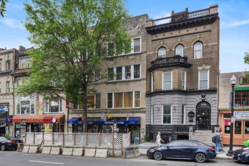 a building on a city street with cars parked in front at 1734 Comfort Stay, 2 Bedrooms, 2 Bath with Kitchen & Wi-Fi in Washington, D.C.