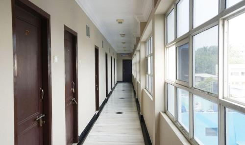 an empty hallway in a building with windows at Hotel Sun Rock in Kanyakumari