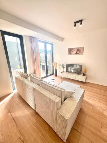 a living room with couches and a couch at Moderný apartmán so súkromnou terasou v centre mesta in Banská Bystrica