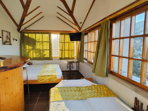 a room with two beds and windows in it at Park Hotel Amfora -Free Parking in Sofia