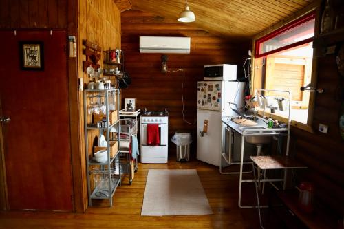 a small kitchen with a stove and a sink at Hacienda La Loma Cozy Retreat with Jacuzzi & Views in Cidra