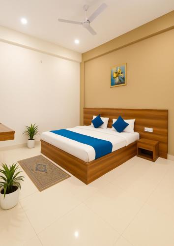 a bedroom with a large bed with blue pillows at The Silverkey Hospitalilty - Krishiv palace Hotel in Vrindāvan
