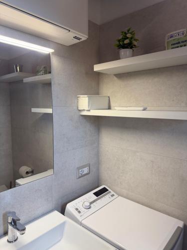 a bathroom with a toilet and a sink and a mirror at Panoramicissima in Costa Rei
