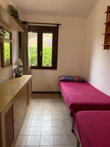 a room with two beds and a window at Panoramicissima in Costa Rei