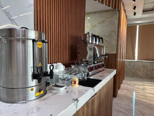 a kitchen with a counter with a coffee maker at Al Jawahiri Hotel in Erbil