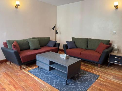 a living room with two couches and a coffee table at Tano Bora Villa in Sekenani