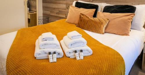 a bed with towels on top of it at Studio with additional sofa bed - Eastbourne in Eastbourne