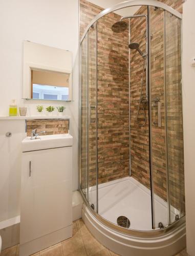 a bathroom with a shower with a toilet and a sink at Studio with additional sofa bed - Eastbourne in Eastbourne