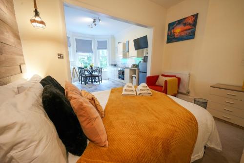 a bedroom with a large bed with two pillows on it at Studio with additional sofa bed - Eastbourne in Eastbourne