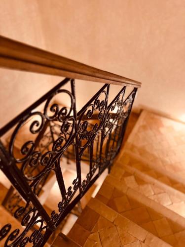 a staircase with a wrought iron railing in a house at NOUR Tamraght in Tamraght Ouzdar