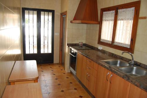 a kitchen with a sink and a counter top at Villa Maria Beach Villa in Moraira