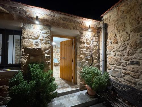 an entrance to a stone building with a wooden door at Traditional house Nikos in Roussokhória