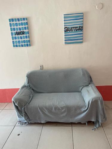 a couch sitting on a floor in a room at Beira Mar Hostal Buzios in Búzios