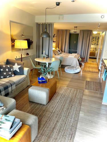 a large living room with a bed and a couch at Holiday Home Birdie in Naantali
