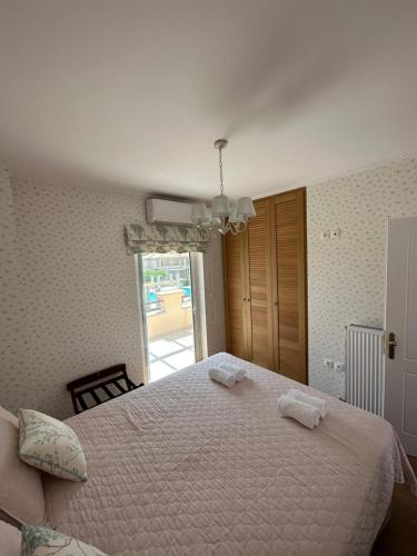 a bedroom with a large bed with two towels on it at Villa Myrto Nafpaktos in Nafpaktos
