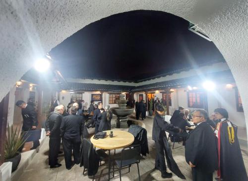 a group of people standing around a table in a room at Hotel Boutique Mitad Del Mundo in Quito