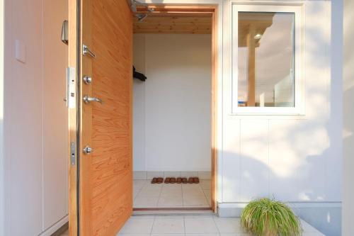 a door leading into a room with a window at Rental House Towada in Towada