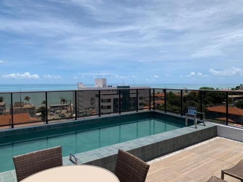 a swimming pool on the roof of a building at UNO Flats 104 - 50m from the beach in João Pessoa