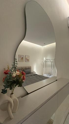 a bedroom with a large mirror on the wall at الغزال in Al Hofuf