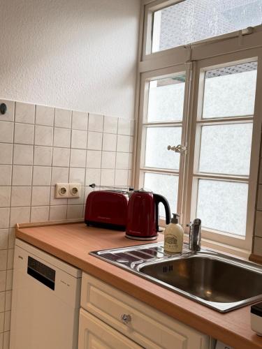 a kitchen with a sink and a counter top at Ferienwohnung Altes Gut Kenkhausen in Wermelskirchen