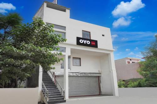 a white building with a ovo sign on it at Hotel O The Skyrise Lucknow Hotel in Kākori
