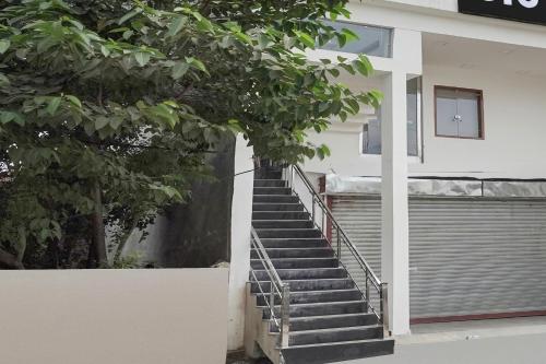 a staircase leading up to a building with a door at Hotel O The Skyrise Lucknow Hotel in Kākori