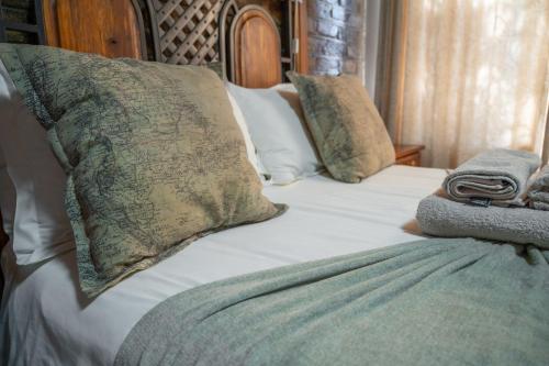a bed with two pillows on top of it at The Palms Guest House in Hopetown