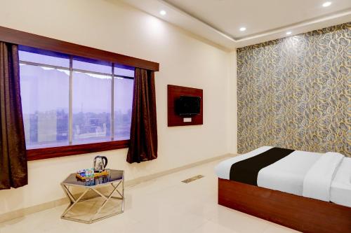 Postel nebo postele na pokoji v ubytování Hotel O Palm Bliss Hotels & Resorts