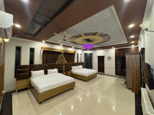 a hotel room with two beds and a ceiling at The Bless inn Hotel in Islamabad