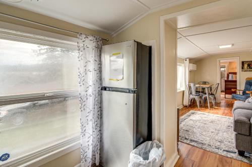 a refrigerator in a living room with a window at Walk to Mingus Park Quaint Escape with Private Yard in Coos Bay