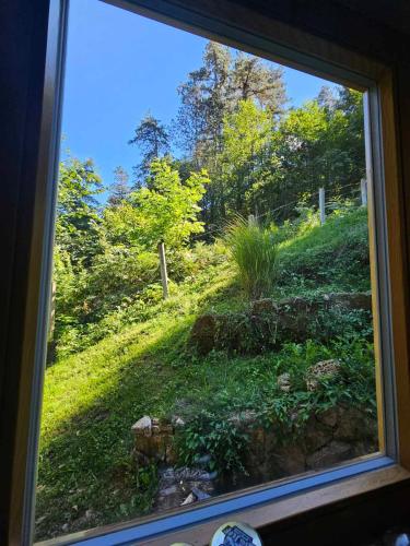 a view of a field from a window at Vikendica Šehić in Zavidovići