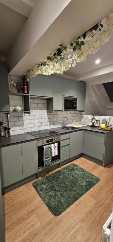 a kitchen with gray cabinets and a green rug at Amazing Central Windsor Flat Contractors welcome in Windsor