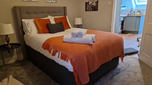 a bedroom with a bed with two towels on it at Amazing Central Windsor Flat Contractors welcome in Windsor