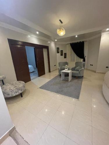 a living room with a couch and a table at BQq in Banī Ghālib