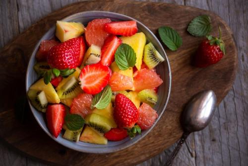 a bowl of fruit on a wooden table at Lalagunebages, Panoramic View in Bages