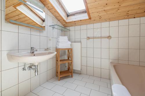 a bathroom with a sink and a bath tub at Pleschinhof in Velden am Wörthersee