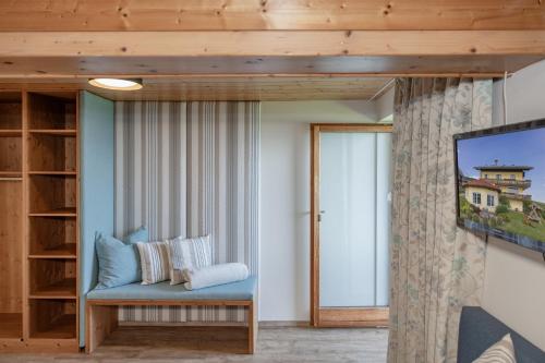 a living room with a blue couch and a window at Pleschinhof in Velden am Wörthersee
