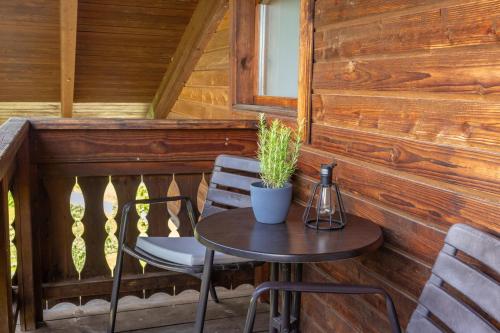 a small table and chairs on the porch of a cabin at Pleschinhof in Velden am Wörthersee