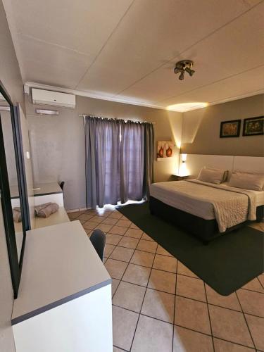 a hotel room with a bed and a window at ZUCH Accommodation at Pafuri Self Catering - Guest Apartment in Polokwane