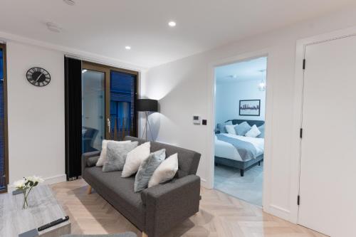 a living room with a couch and a bed at 2 Bed Apartment, in the heart of Manchester City Centre! 7 mins walk from Piccadilly Station! in Manchester
