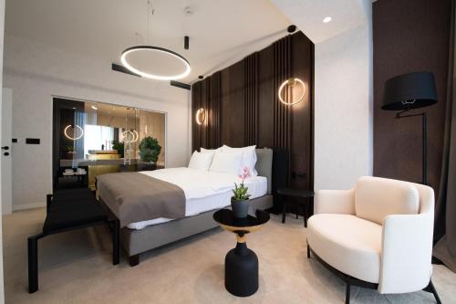 a hotel room with a bed and a chair at Premium Hotel, Novi Sad in Novi Sad