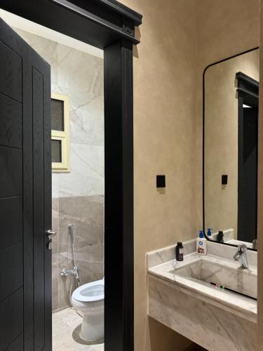 a bathroom with a sink and a toilet at Luxury 2BR - Steps To Boulevard in Riyadh