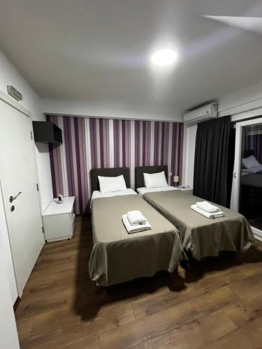 a hotel room with two beds in a room at VilaMihaela in Skopje
