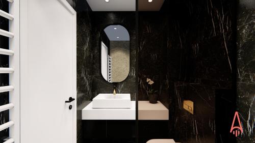 a bathroom with a white sink and a mirror at Premium Hotel, Novi Sad in Novi Sad