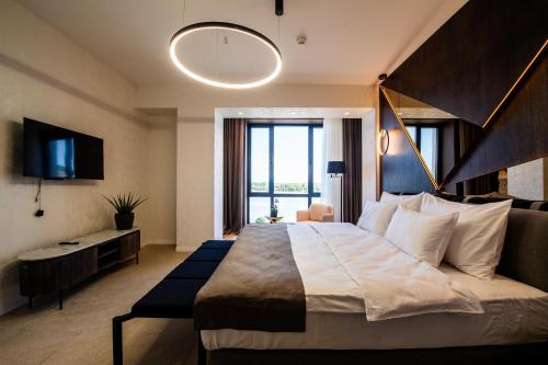 a bedroom with a large bed and a large window at Premium Hotel, Novi Sad in Novi Sad